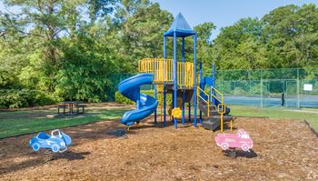 A playground with a blue slide and a yellow structure
